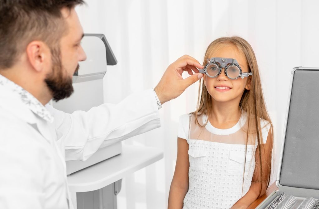 Young girl having an eye exam from her optometrist.
